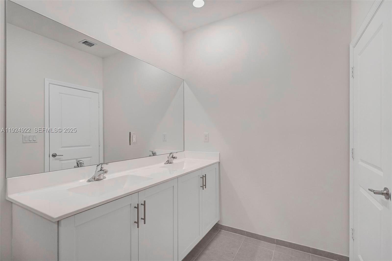 13405 Southwest 285th Street, Unit 13405 Homestead, FL 33033 - Photo 49 of 59 a bathroom with a sink and a mirror