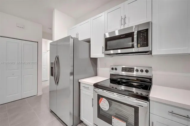 a kitchen with a refrigerator stove and microwave