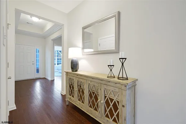a view of an entryway with wooden floor