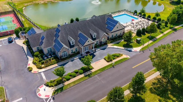 an aerial view of a house with a garden and lake view