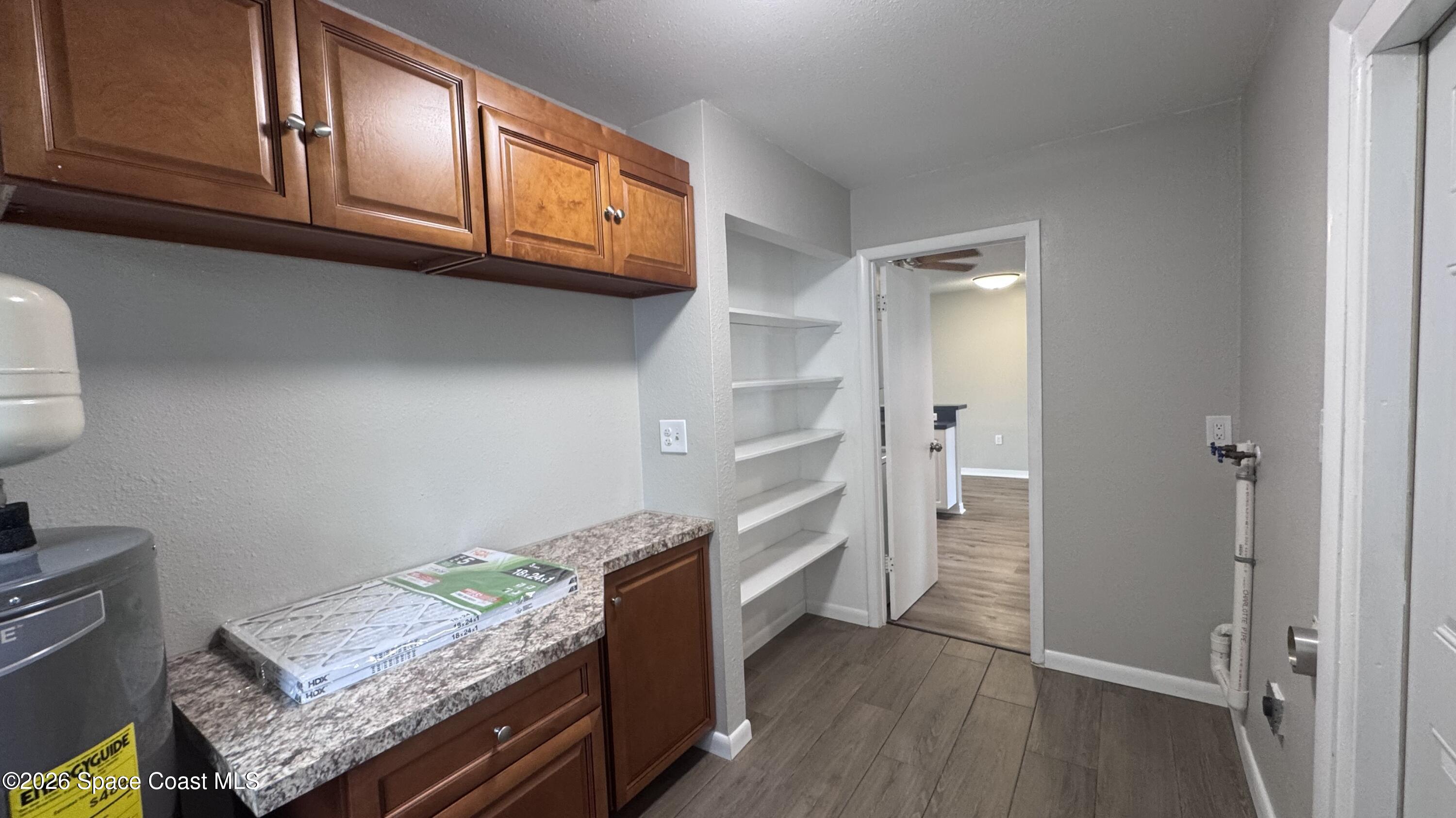 2137 Laden Road Melbourne, FL 32935 - Photo 21 of 23 a kitchen with granite countertop wooden cabinets and a stainless steel appliances