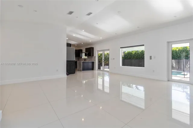 a view of a kitchen with a sink and a large window