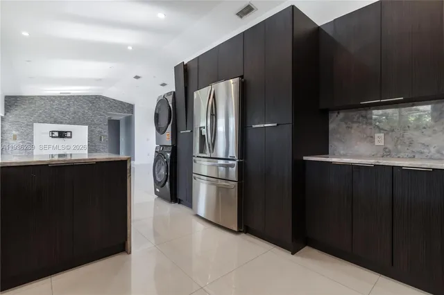 a kitchen with stainless steel appliances a refrigerator and a stove