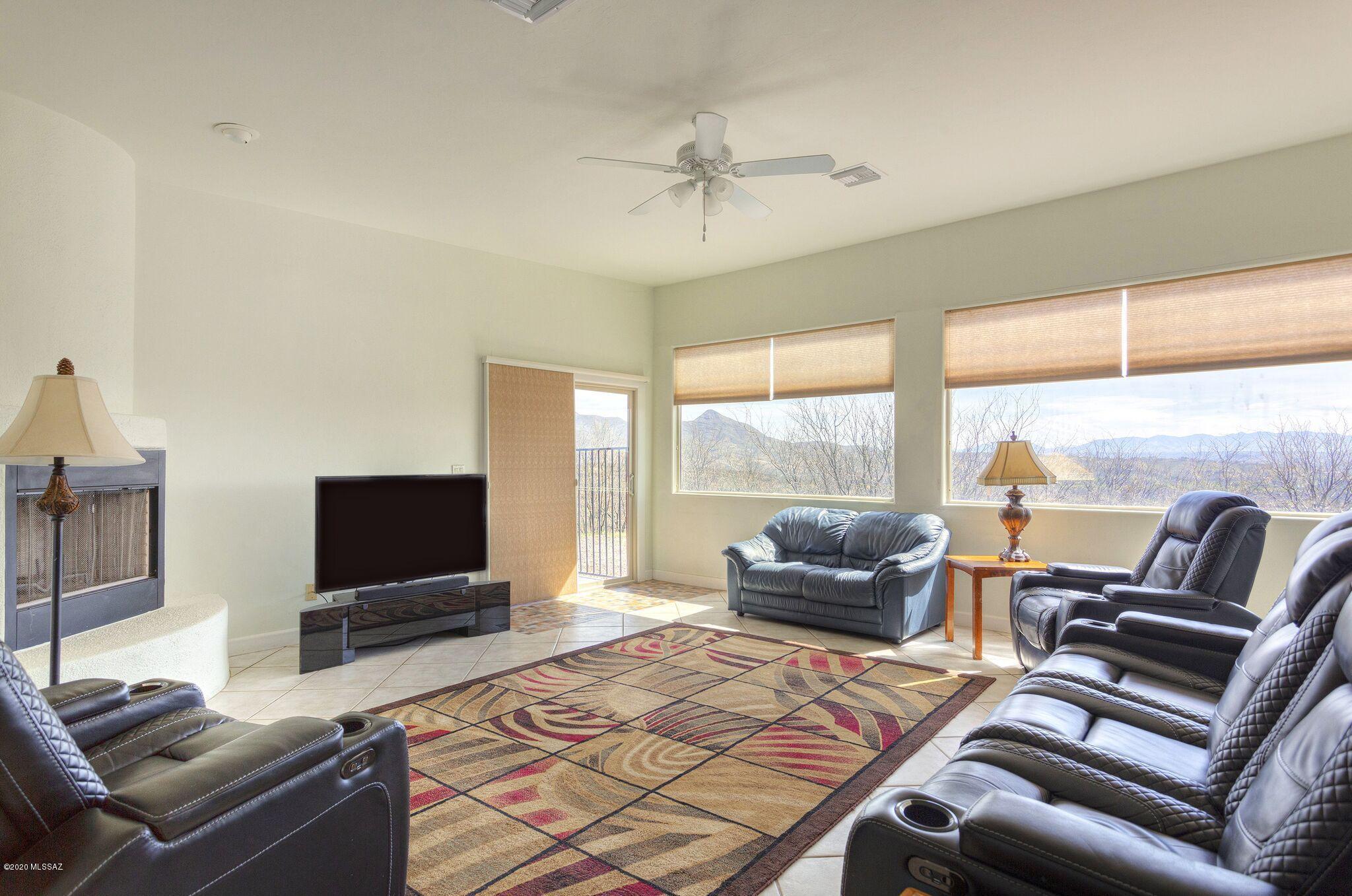 1253 Calle Tubatana Rio Rico, AZ 85648 - Photo 2 of 22 a living room with furniture and a flat screen tv