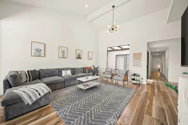 a living room with furniture and a chandelier