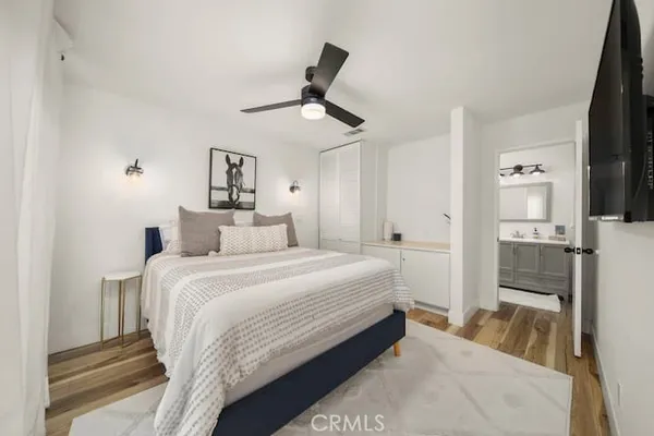 a bedroom with a bed and a large mirror