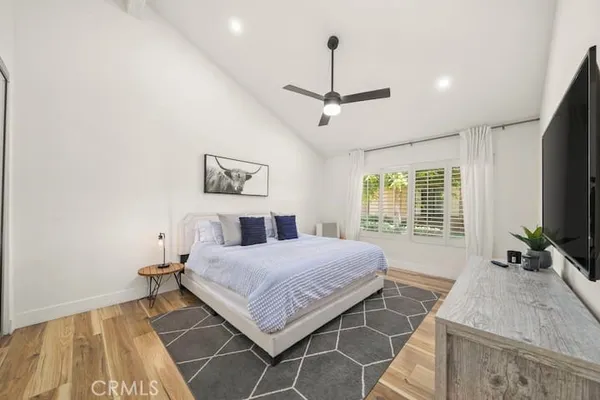 a bedroom with a bed couch and window
