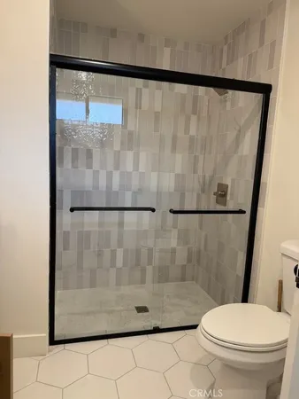a bathroom with a shower and a toilet