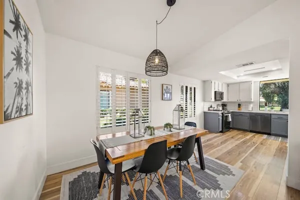 a view of a dining room with furniture window and wooden floor
