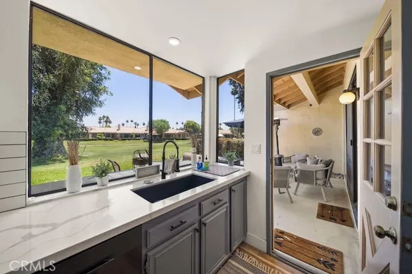 a kitchen with a large window and sink