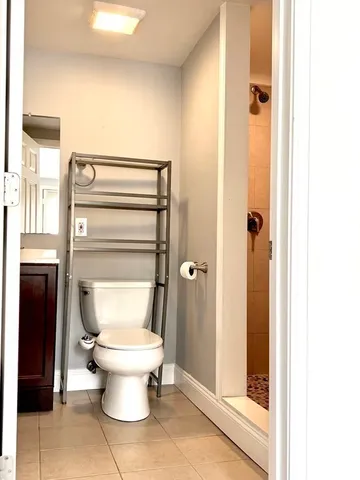a bathroom with a toilet and a shower