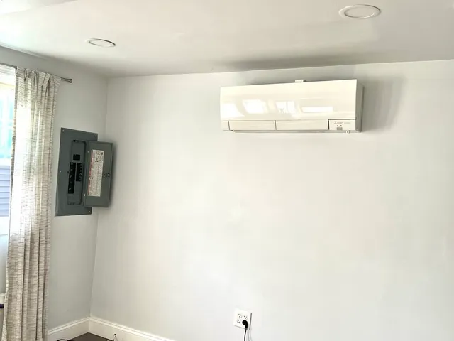 a bathroom with a window and a shower