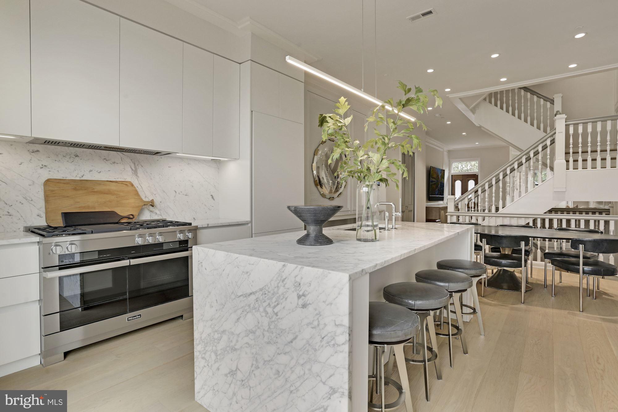 424 C Street Northeast Washington, DC 20002 - Photo 6 of 26 a kitchen with stainless steel appliances kitchen island a table and chairs in it
