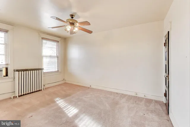 a view of a big room with closet and a ceiling fan
