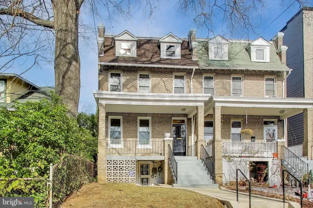 a front view of a building with glass windows and door