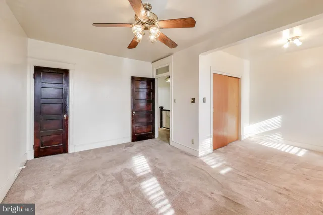 an empty room with windows and closet