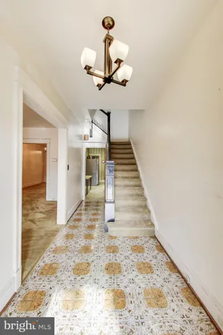a view of an empty room with chandelier