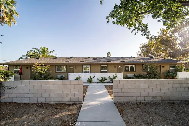 a view of a house with a yard and sitting area