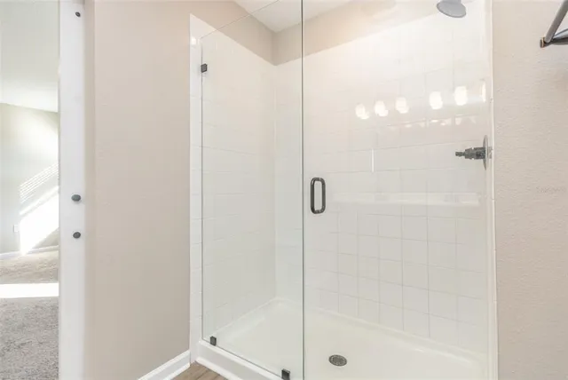 a bathroom with a glass shower door