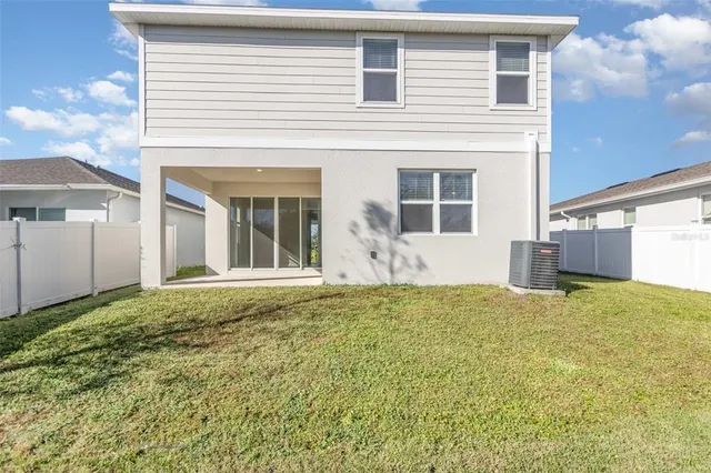 a view of an house with backyard and space