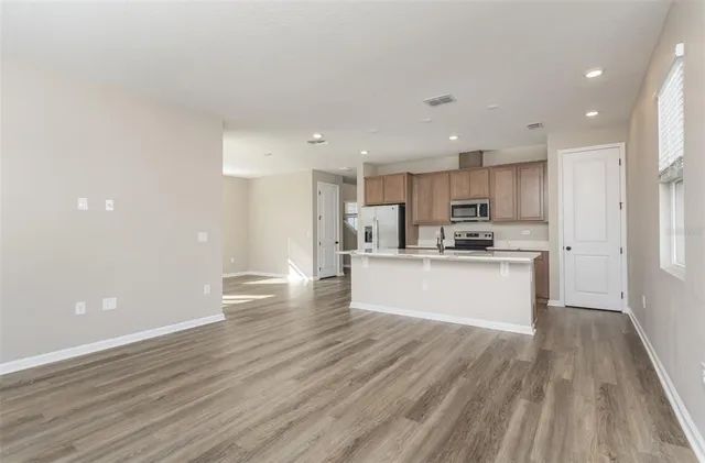 a view of kitchen view wooden cabinets and wooden floor