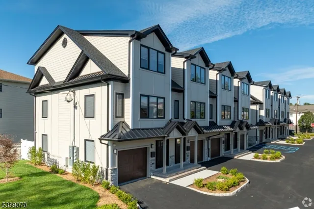a view of a house with swimming pool and sitting area