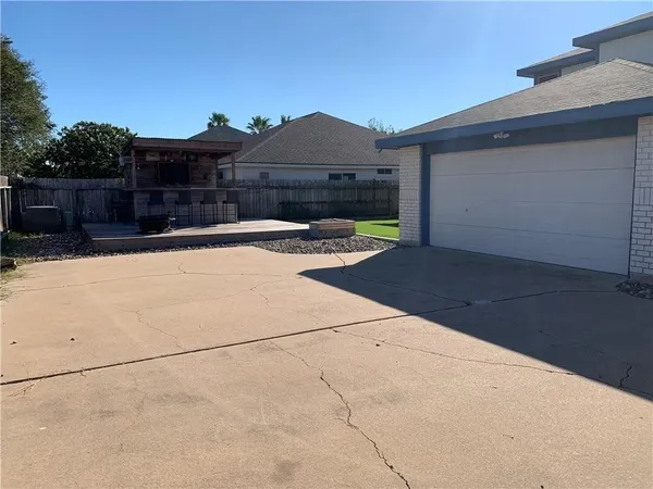 a view of a house with wooden fence