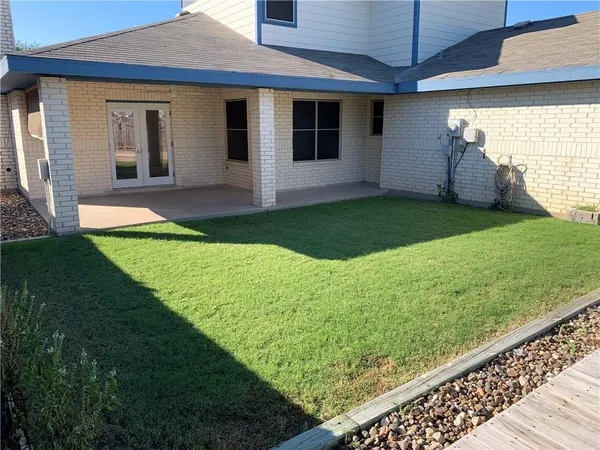 a view of a house with backyard and porch