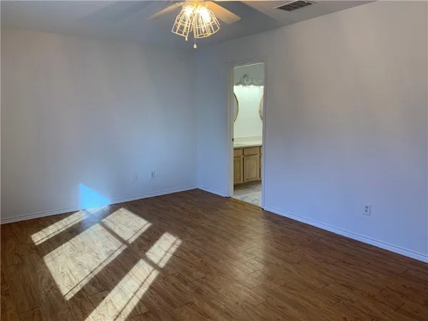 a view of an empty room and wooden floor