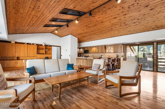 an empty room with wooden floor and furniture