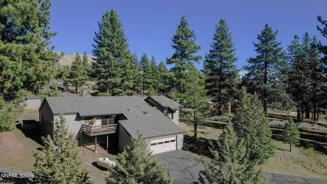 an aerial view of a house with garden space and street view