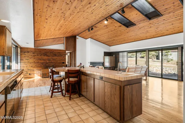 a view of a kitchen with granite countertop a sink and a table