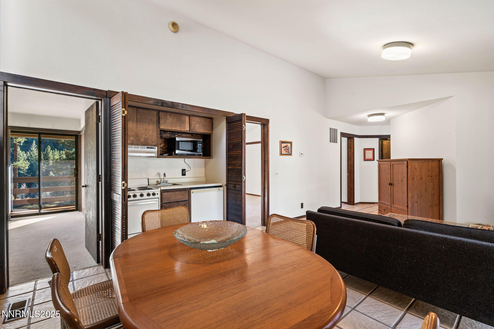 4650 Old Clear Creek Road Carson City, NV 89705 - Photo 40 of 59 a kitchen with stainless steel appliances kitchen island granite countertop a refrigerator a stove a sink dishwasher with a dining table and chairs