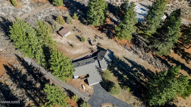 an aerial view of a house with a yard