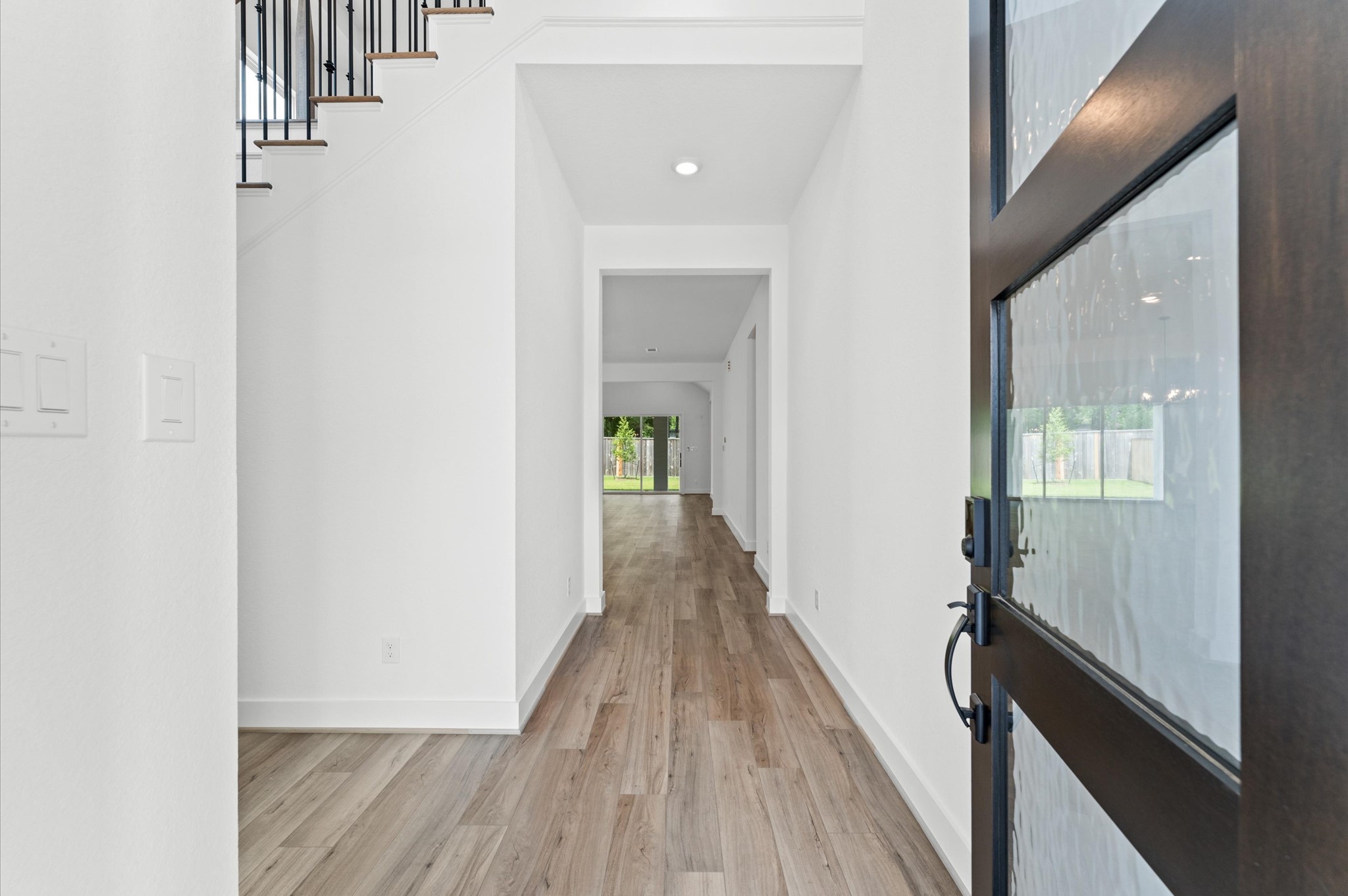 8218 Sherman Pk Trail Spring, TX 77389 - Photo 3 of 28 a view of a hallway with wooden floor and staircase