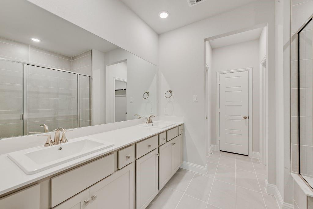 8159 Challenger Lane Frisco, TX 75034 - Photo 11 of 36 a bathroom with a double vanity sink mirror and
