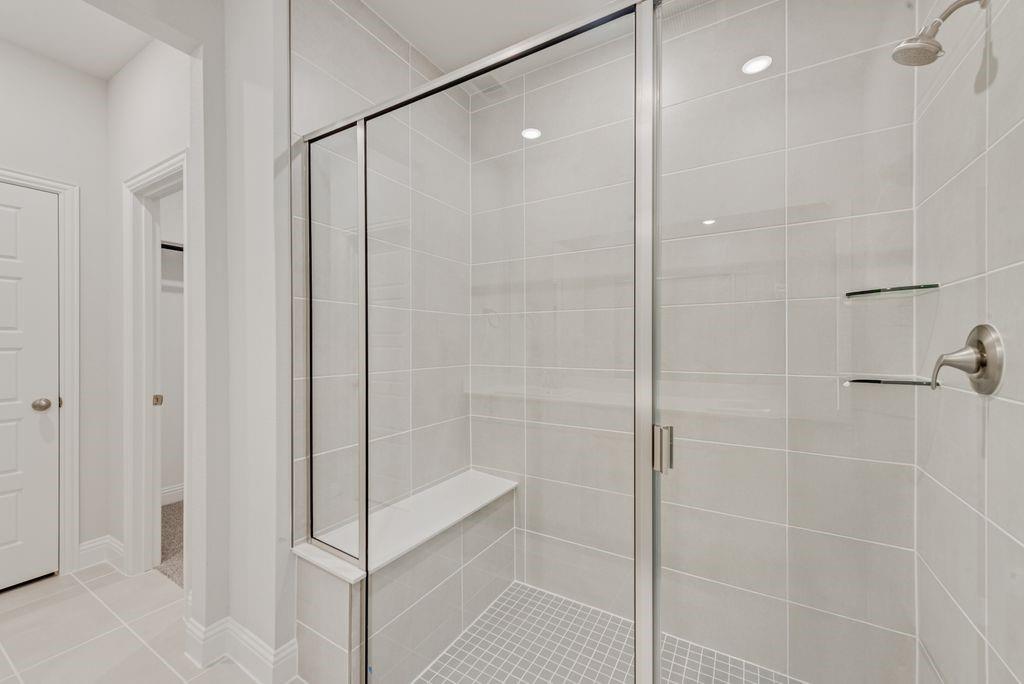 8159 Challenger Lane Frisco, TX 75034 - Photo 12 of 36 a bathroom with a shower and a glass door