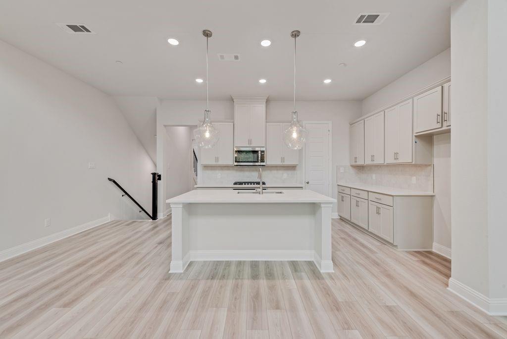 8159 Challenger Lane Frisco, TX 75034 - Photo 2 of 36 a view of kitchen with sink microwave and refrigerator