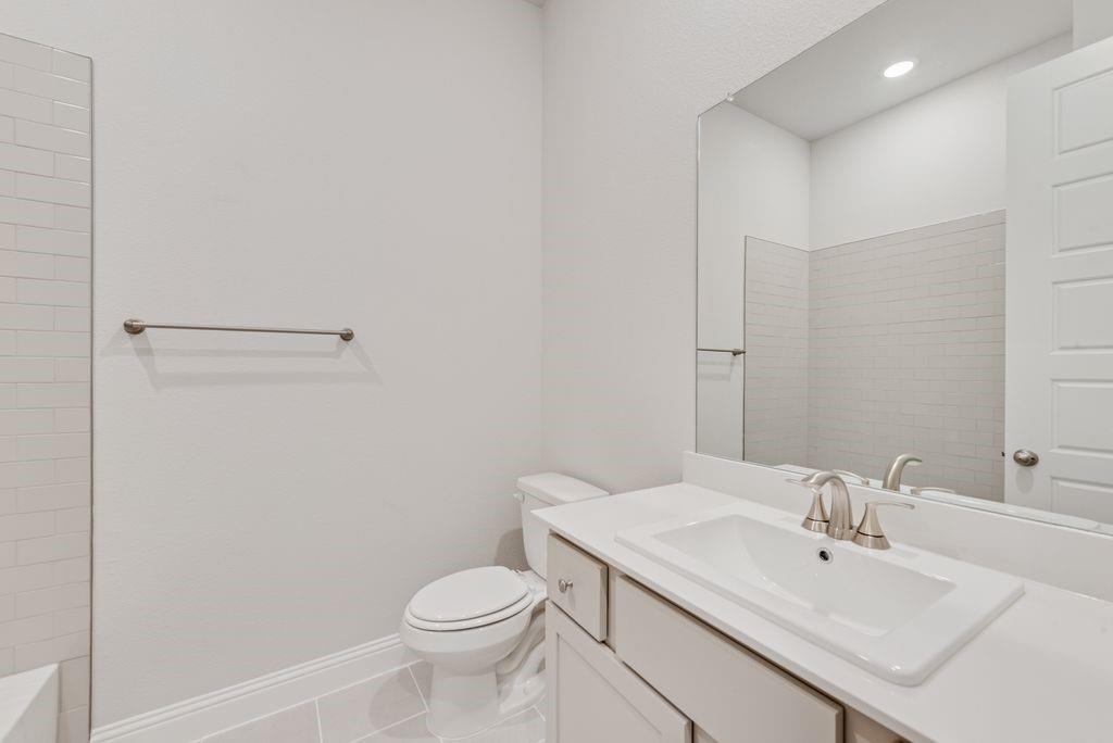 8159 Challenger Lane Frisco, TX 75034 - Photo 22 of 36 a bathroom with a sink a toilet and mirror