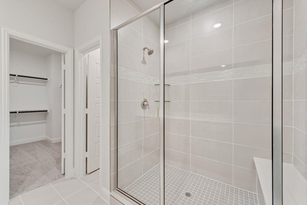 8159 Challenger Lane Frisco, TX 75034 - Photo 26 of 36 a bathroom with a shower and a glass door