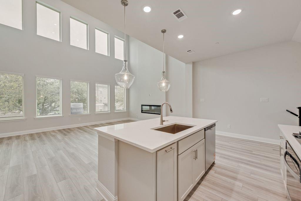 8159 Challenger Lane Frisco, TX 75034 - Photo 3 of 36 a kitchen with a sink stove and wooden floor