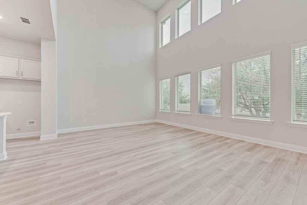 8159 Challenger Lane Frisco, TX 75034 - Photo 8 of 36 wooden floor in an empty room with a window