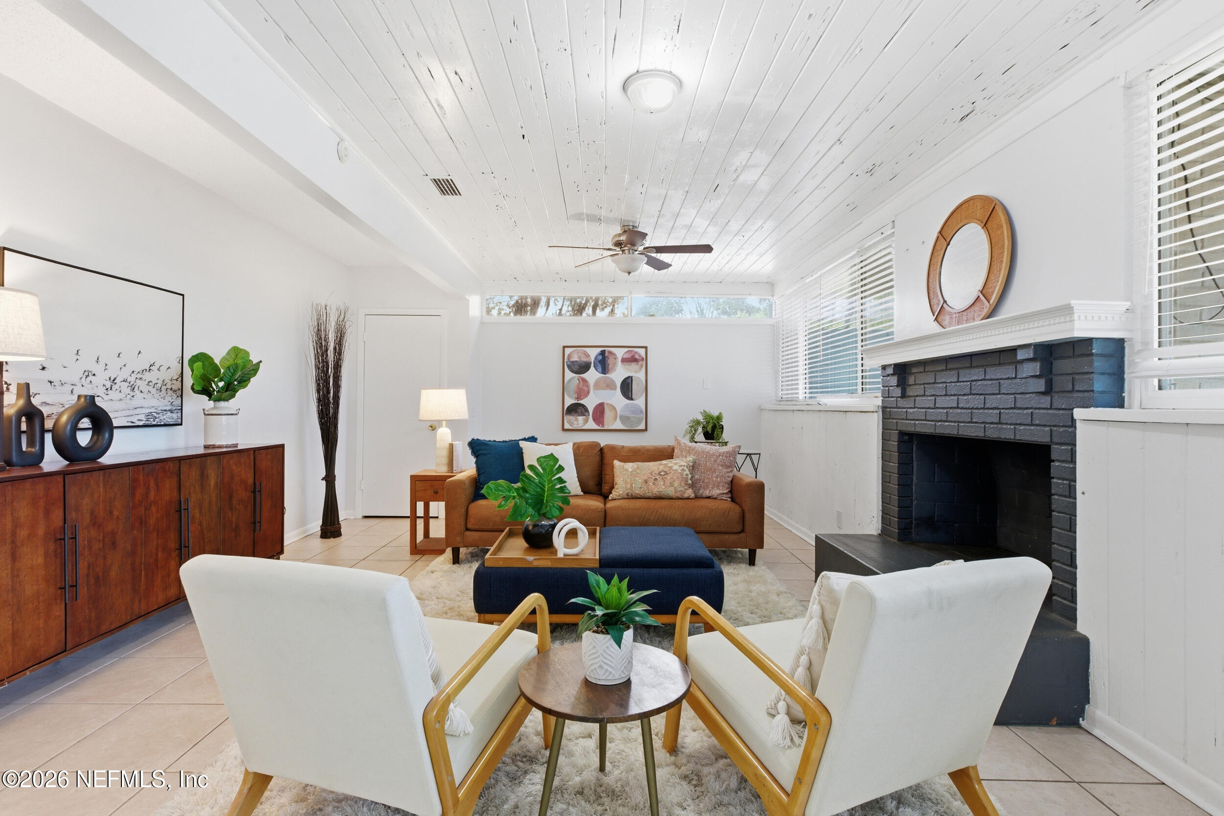 6231 Riviera Manor Drive Jacksonville, FL 32216 - Photo 11 of 33 a living room with furniture a fireplace and a window