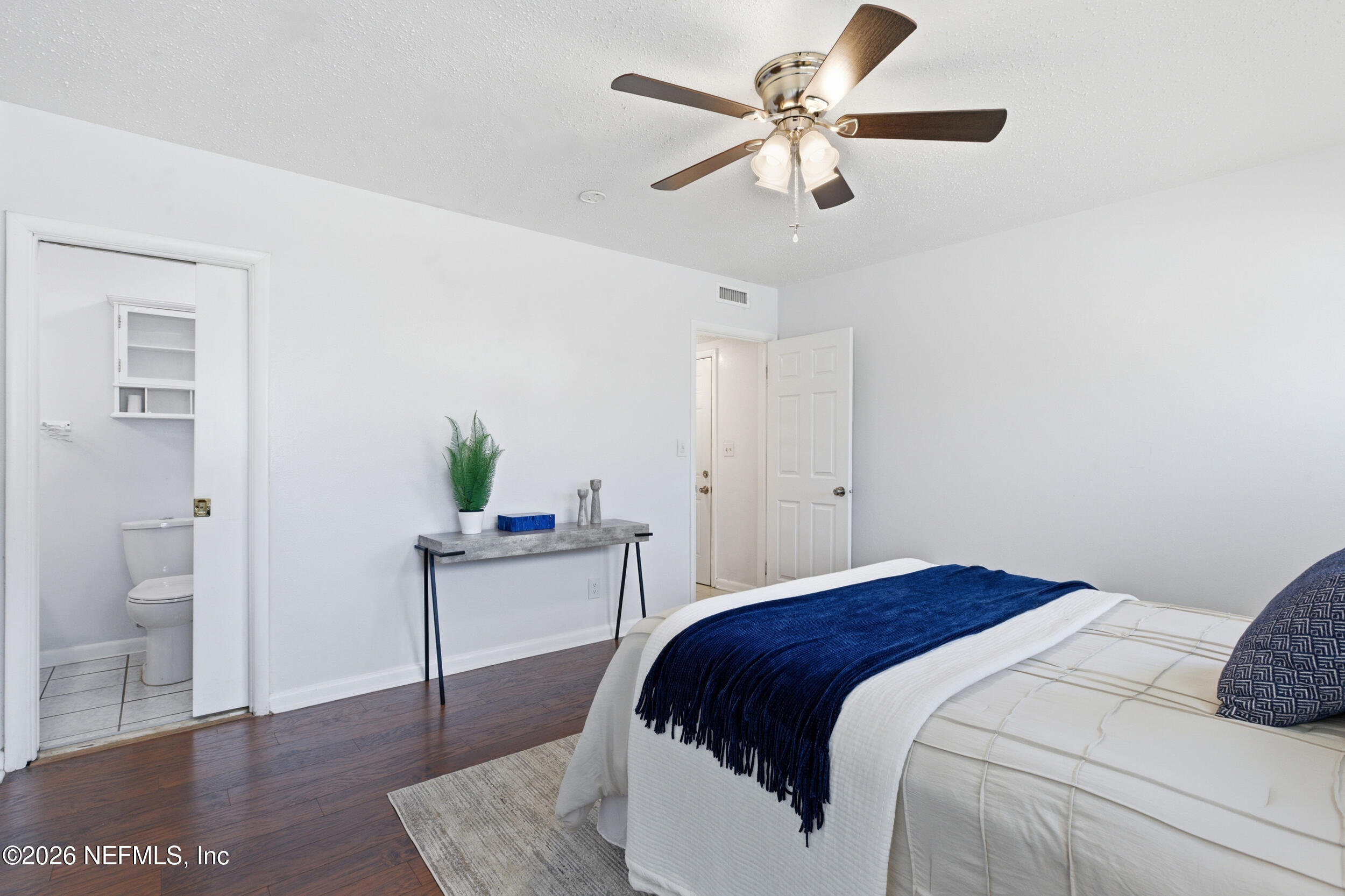 6231 Riviera Manor Drive Jacksonville, FL 32216 - Photo 16 of 33 a bedroom with a bed chandelier and a window