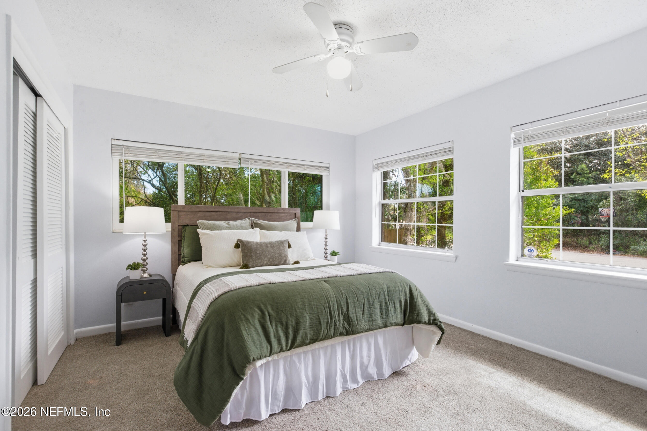 6231 Riviera Manor Drive Jacksonville, FL 32216 - Photo 18 of 33 a bedroom with a large bed and a large window