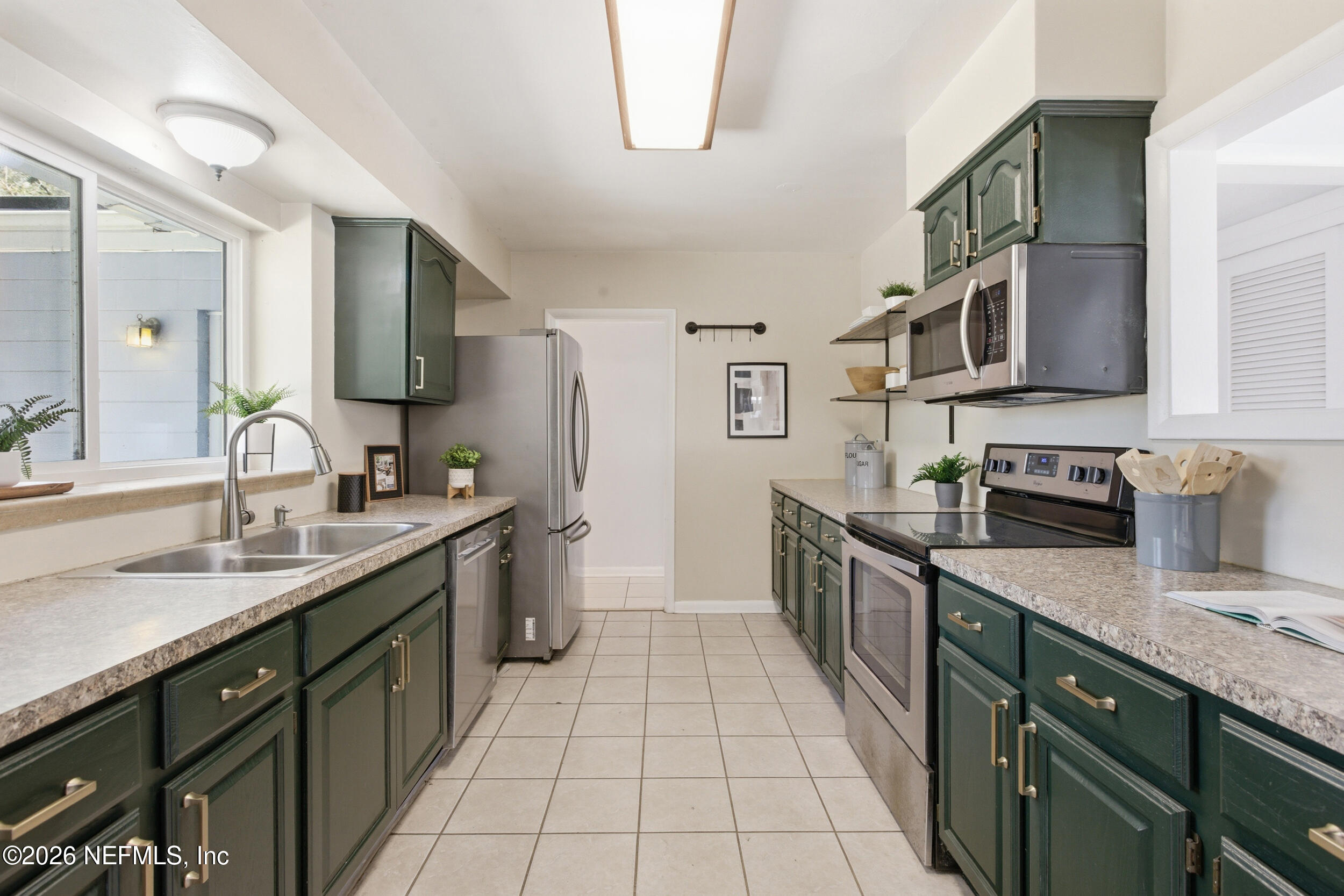 6231 Riviera Manor Drive Jacksonville, FL 32216 - Photo 7 of 33 a kitchen with stainless steel appliances granite countertop a sink stove and cabinets