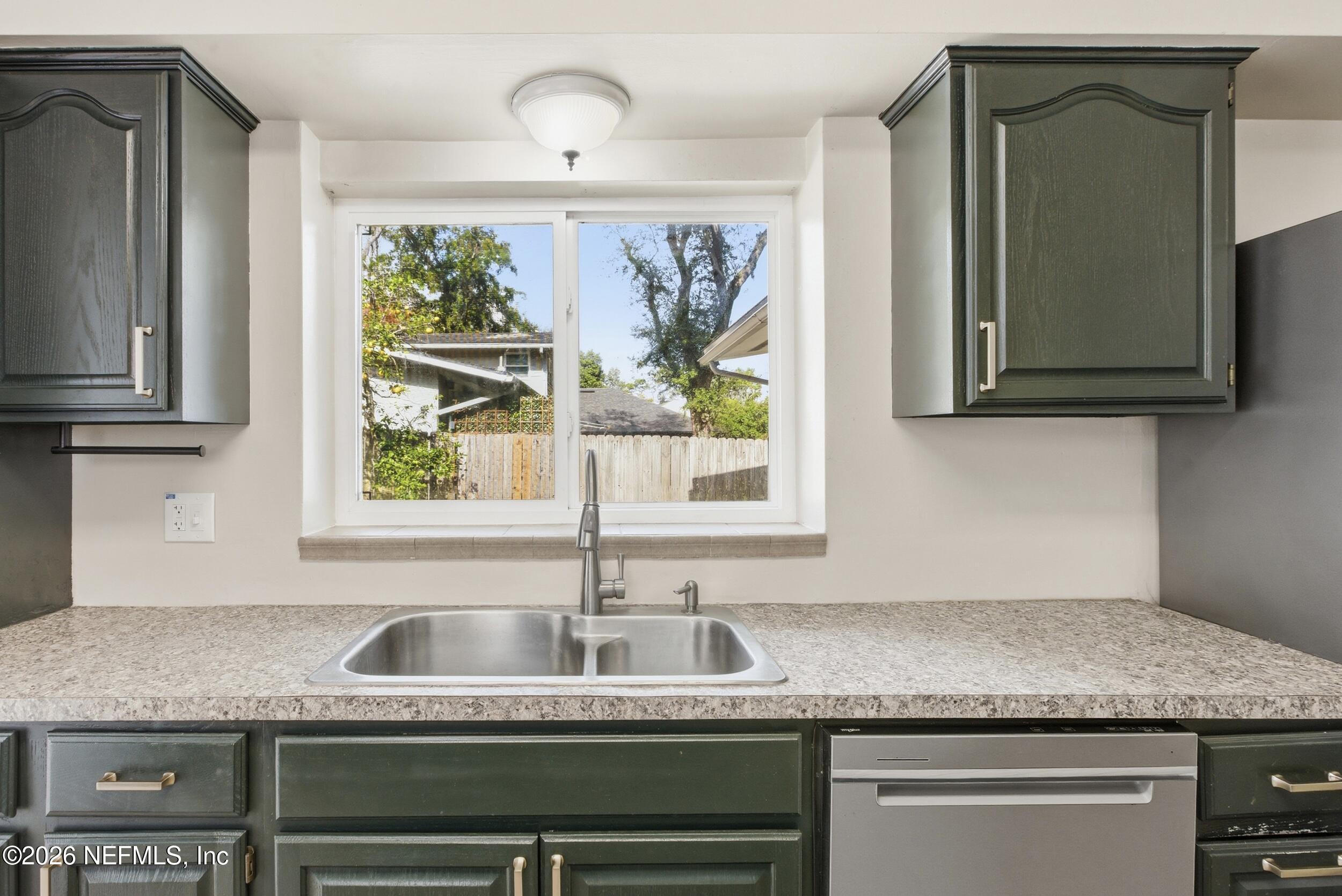 6231 Riviera Manor Drive Jacksonville, FL 32216 - Photo 8 of 33 a kitchen with granite countertop a sink stainless steel appliances and window