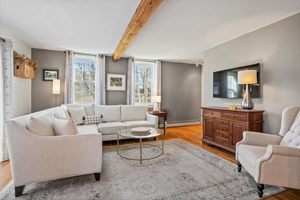 16 Main Street, Unit 3 Pepperell, MA 01463 - Photo 12 of 30 a living room with furniture and a flat screen tv