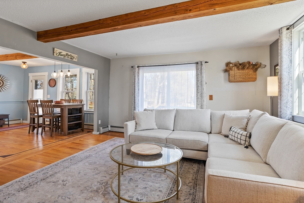 16 Main Street, Unit 3 Pepperell, MA 01463 - Photo 13 of 30 a living room with furniture and a dining table with kitchen view