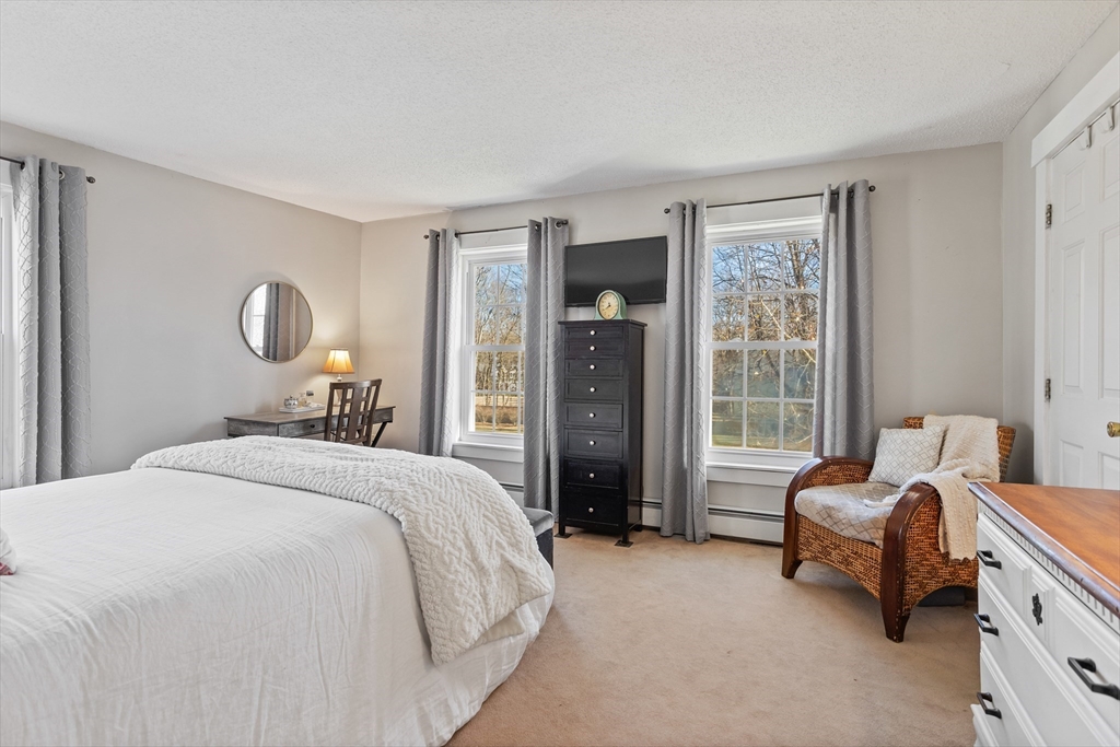 16 Main Street, Unit 3 Pepperell, MA 01463 - Photo 16 of 30 a bedroom with a bed and a couch